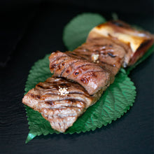 Load image into Gallery viewer, Korean beef galbi, marinated, grilled, and served on a platter.
